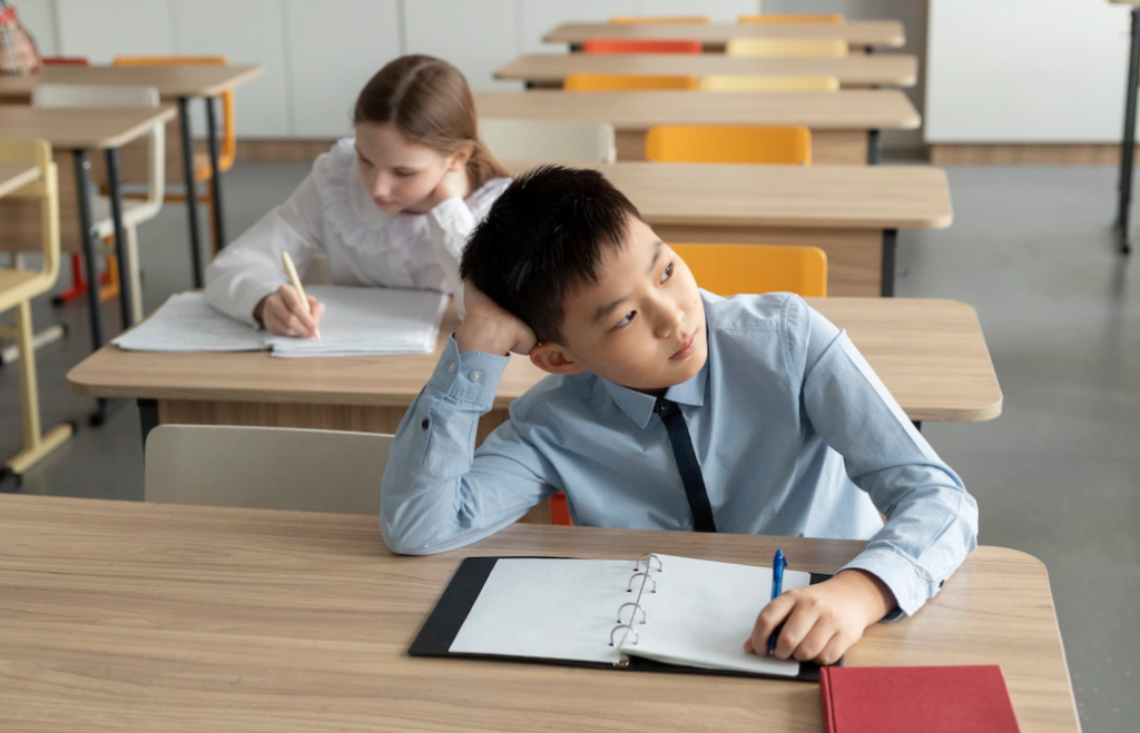 asian kid distracted in classroom