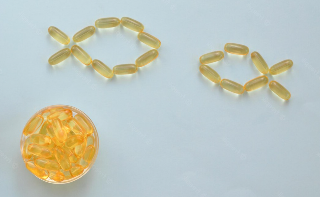Conceptual image of omega 3 capsules in the form of two fish