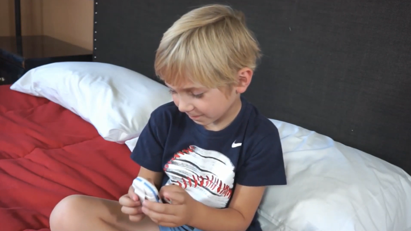 boy with a chummie premium bed wetting alarm in hands